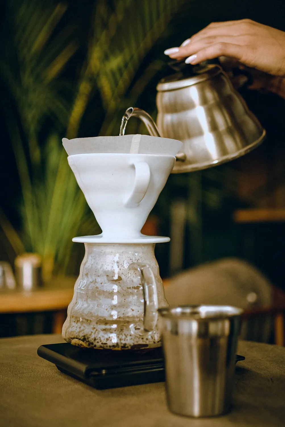 A careful pour-over brewing process with a gooseneck kettle